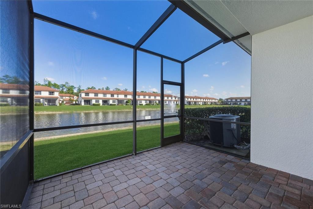 7770 Bristol Circle Naples, FL 34120 - Photo 25 of 36 Unfurnished sunroom with a water view