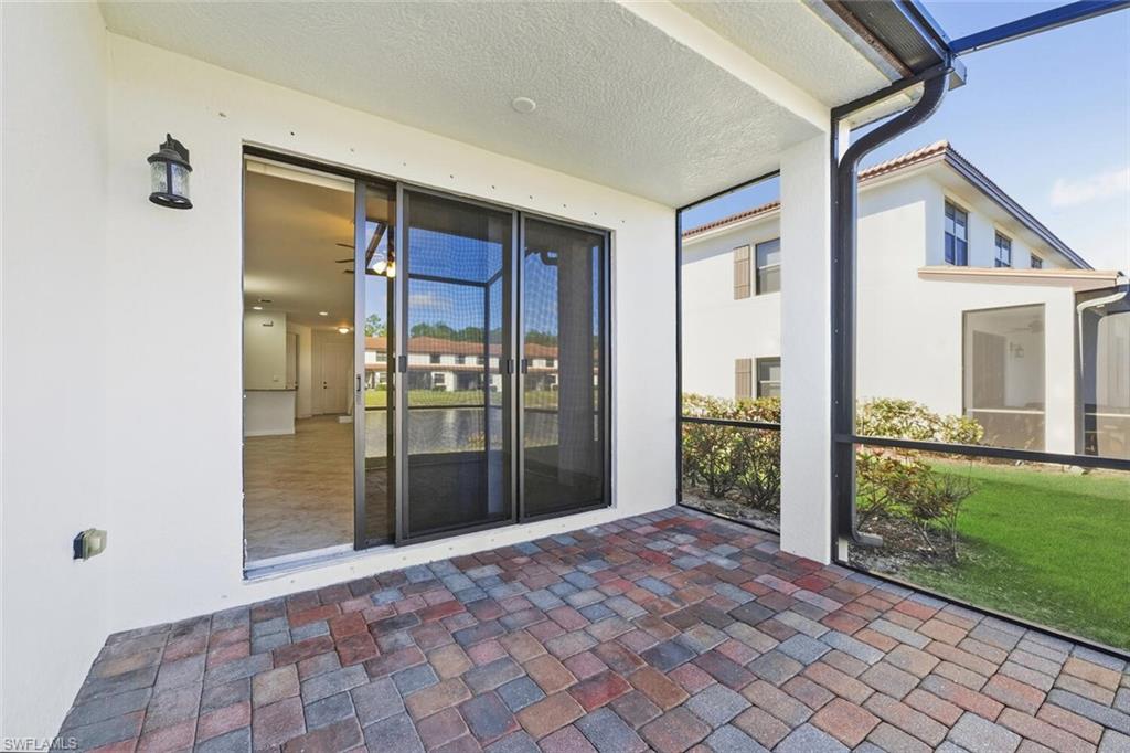 7770 Bristol Circle Naples, FL 34120 - Photo 26 of 36 Property entrance featuring stucco siding and a sunroom