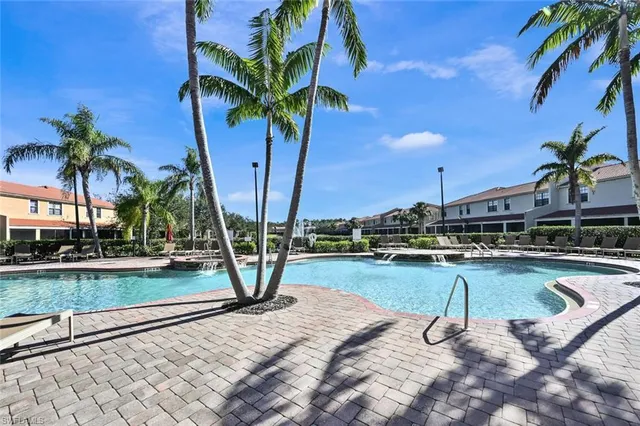 a view of a swimming pool with a table and chairs