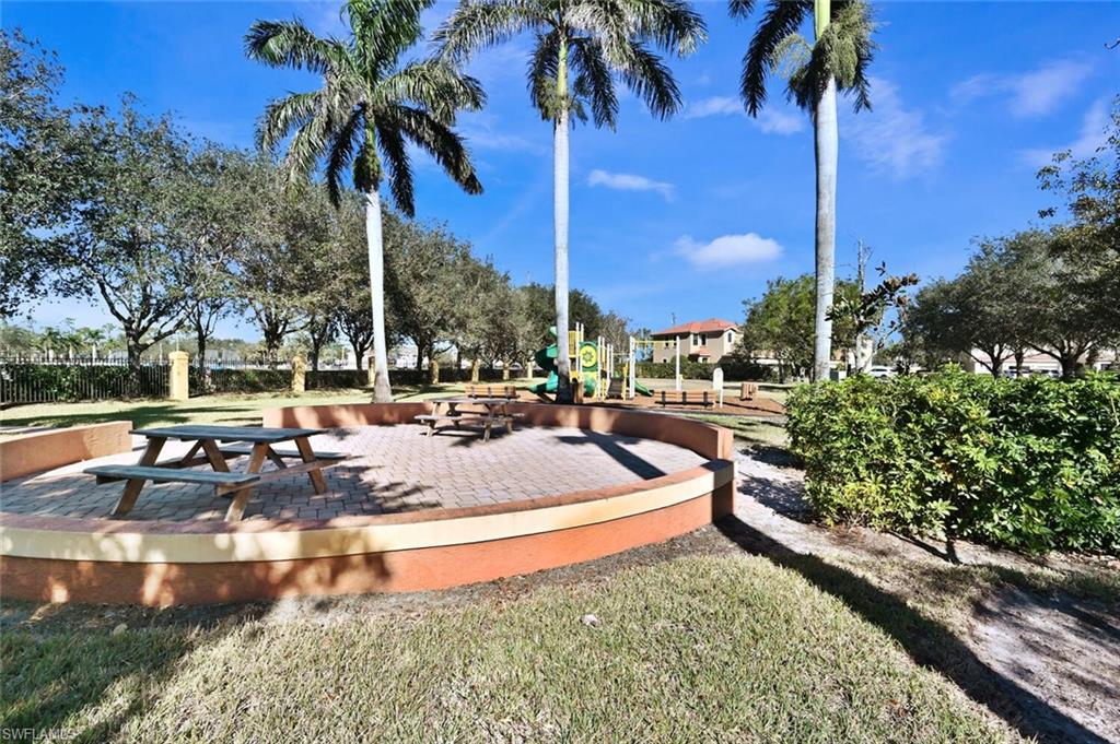 7770 Bristol Circle Naples, FL 34120 - Photo 33 of 36 Surrounding community featuring a patio and a lawn