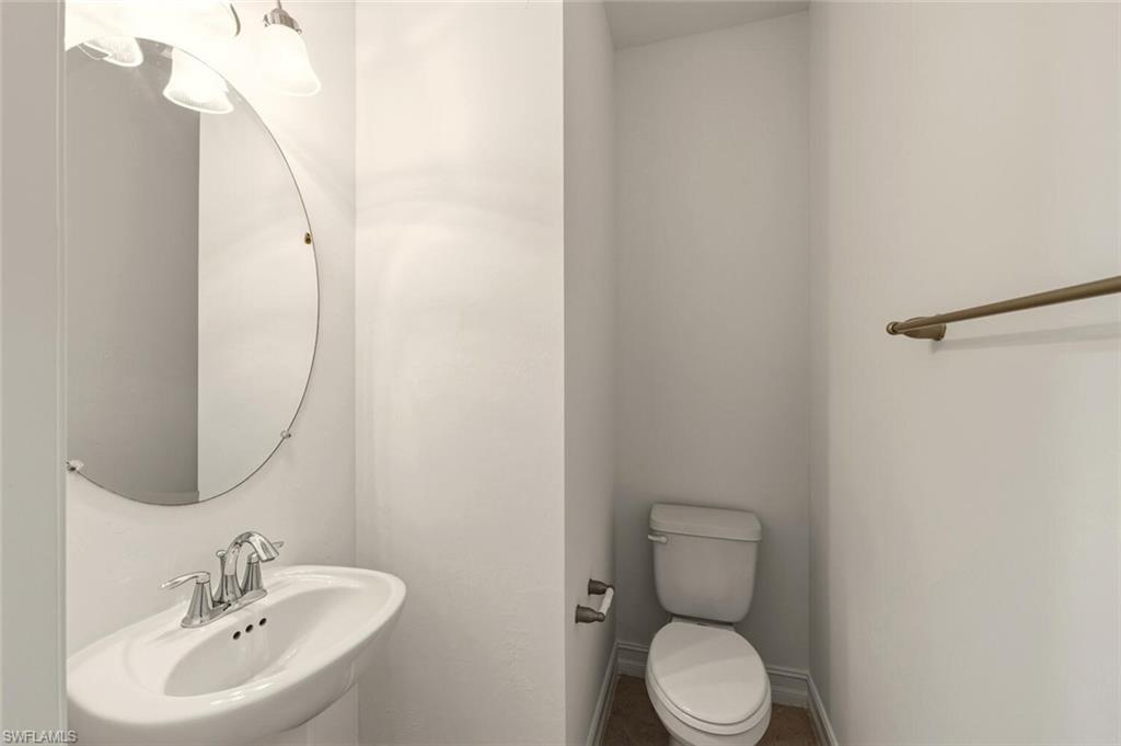 7770 Bristol Circle Naples, FL 34120 - Photo 9 of 36 Half bath with a sink and toilet