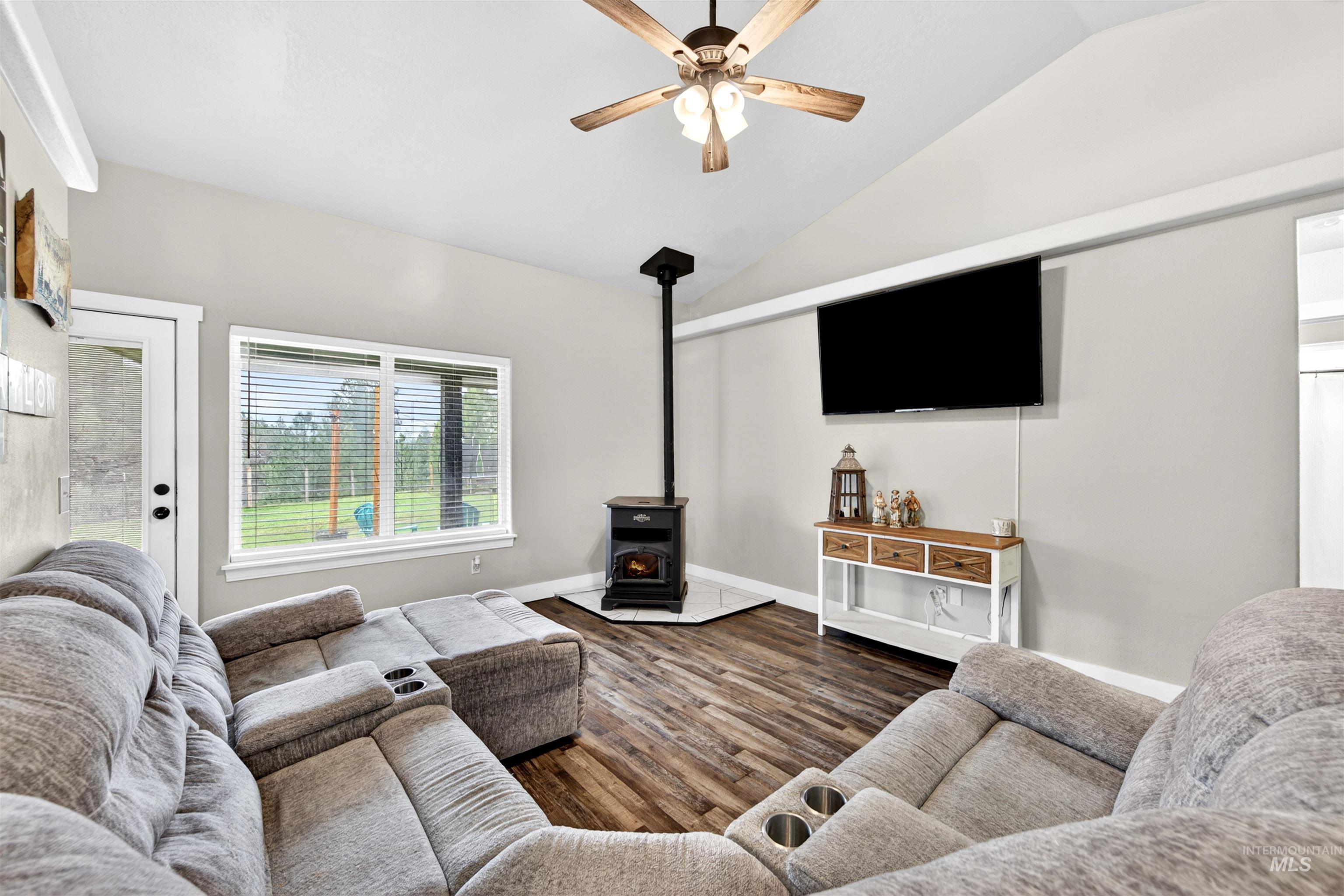 4 Round Up Circle Boise, ID 83716 - Photo 17 of 47 Living area with vaulted ceiling, wood-finish flooring, and a ceiling fan