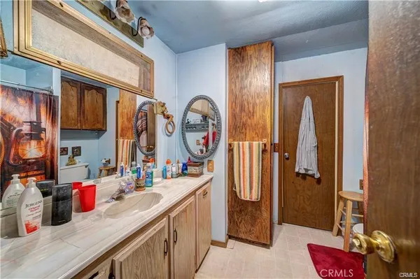 a bathroom with a sink mirror and vanity