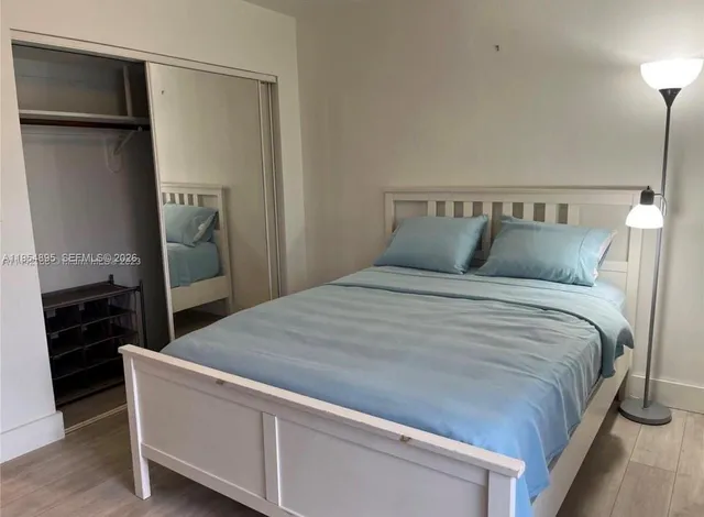 a bedroom with a bed and a large window