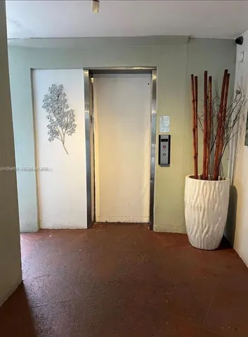 a view of a room with wall closet and a window