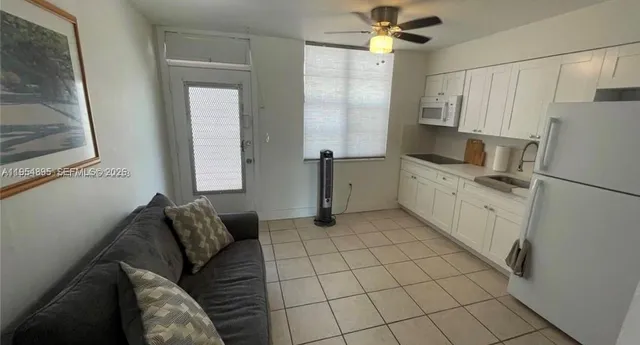 a kitchen with stainless steel appliances a refrigerator sink and cabinets