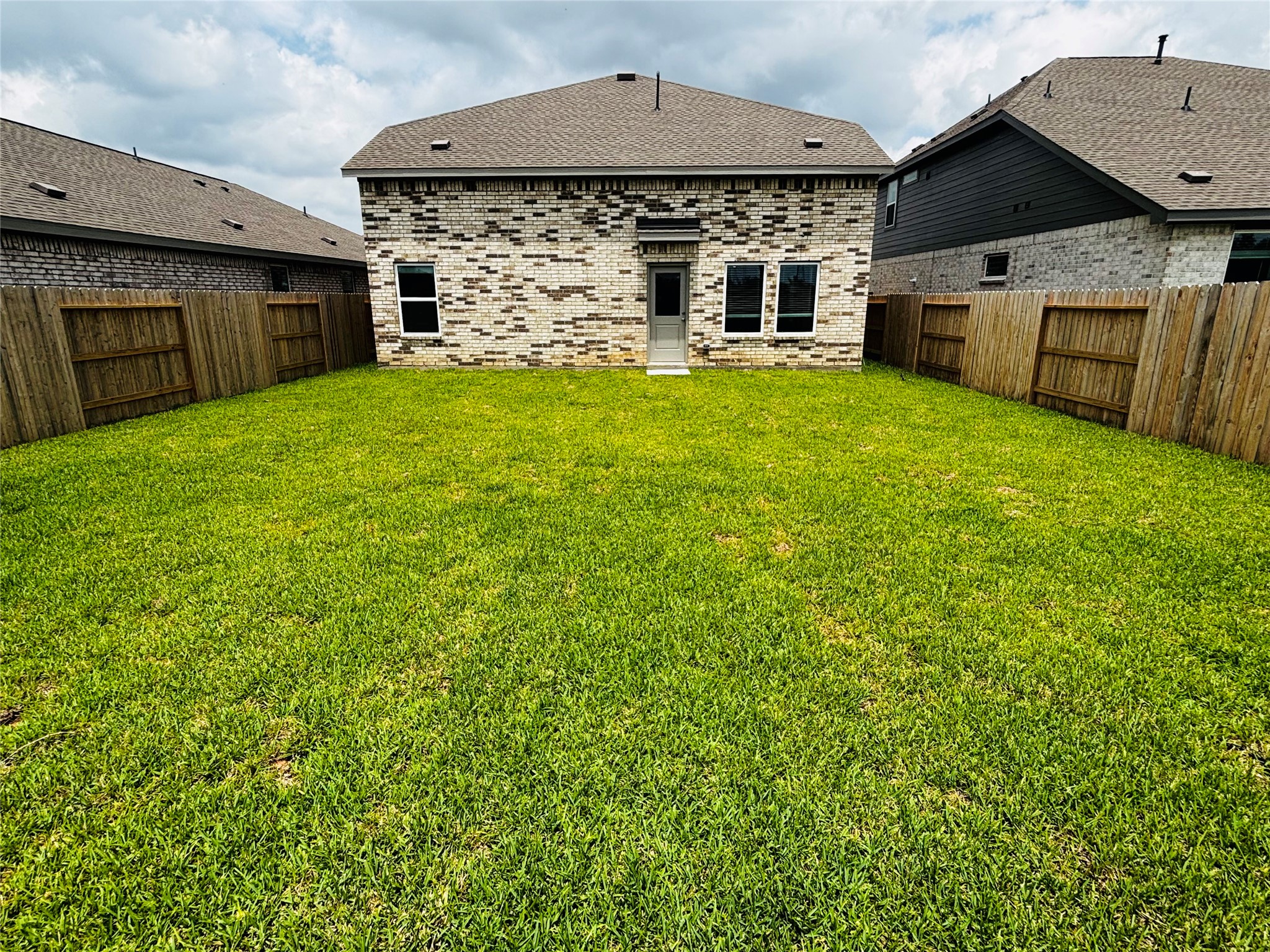 2126 Mosaic Vly Court Angleton, TX 77515 - Photo 34 of 40 a view of a house with a yard and garage
