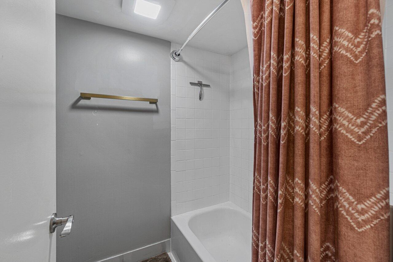 22172 Boca Rancho Drive, Unit D Boca Raton, FL 33428 - Photo 11 of 15 a bathroom with a shower and a tub