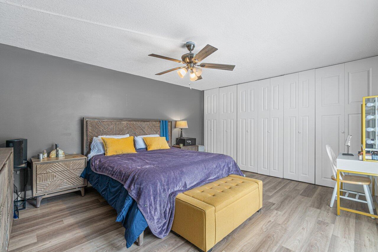 22172 Boca Rancho Drive, Unit D Boca Raton, FL 33428 - Photo 12 of 15 a bedroom with a bed and wooden floor