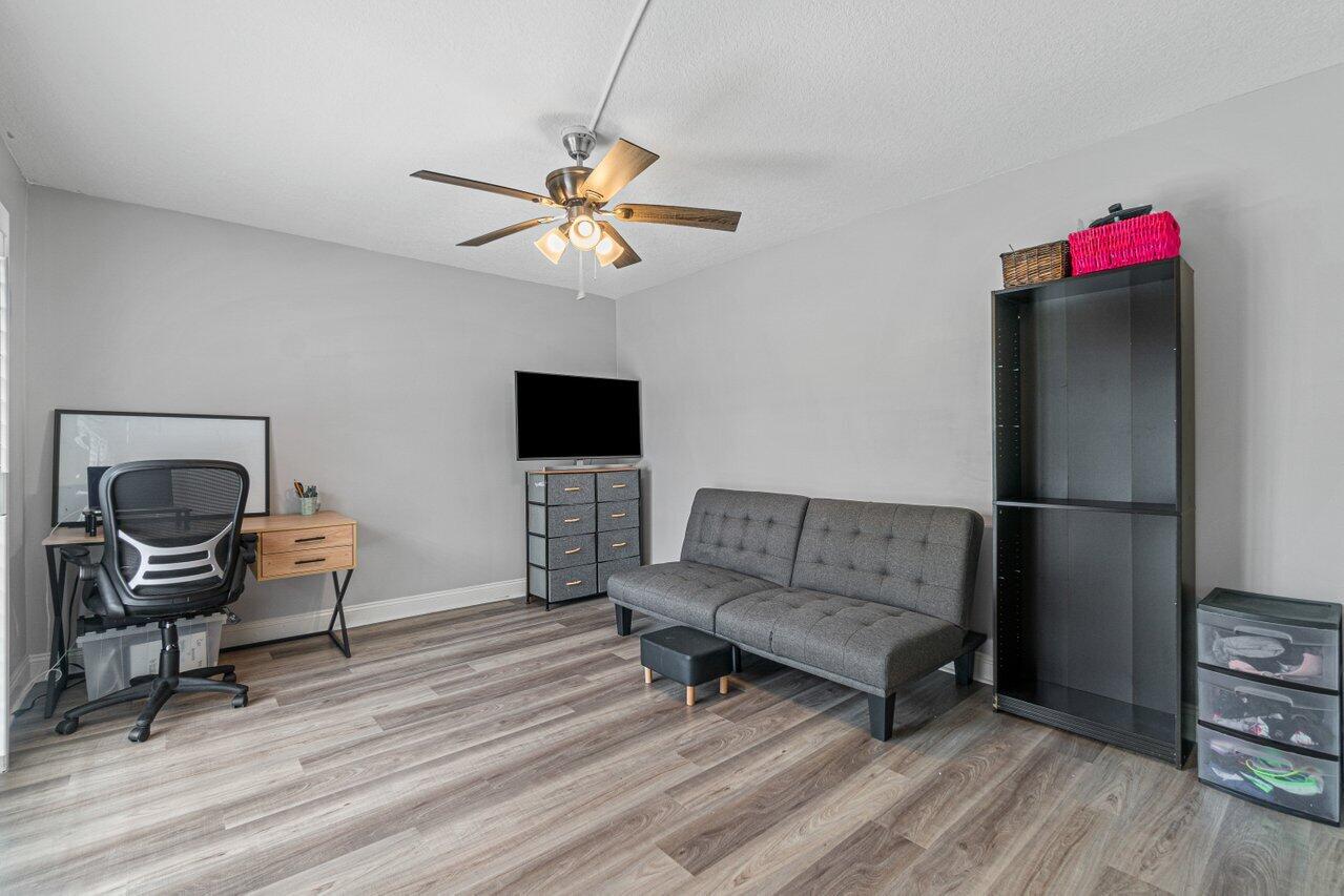 22172 Boca Rancho Drive, Unit D Boca Raton, FL 33428 - Photo 15 of 15 a living room with furniture and a wooden floor
