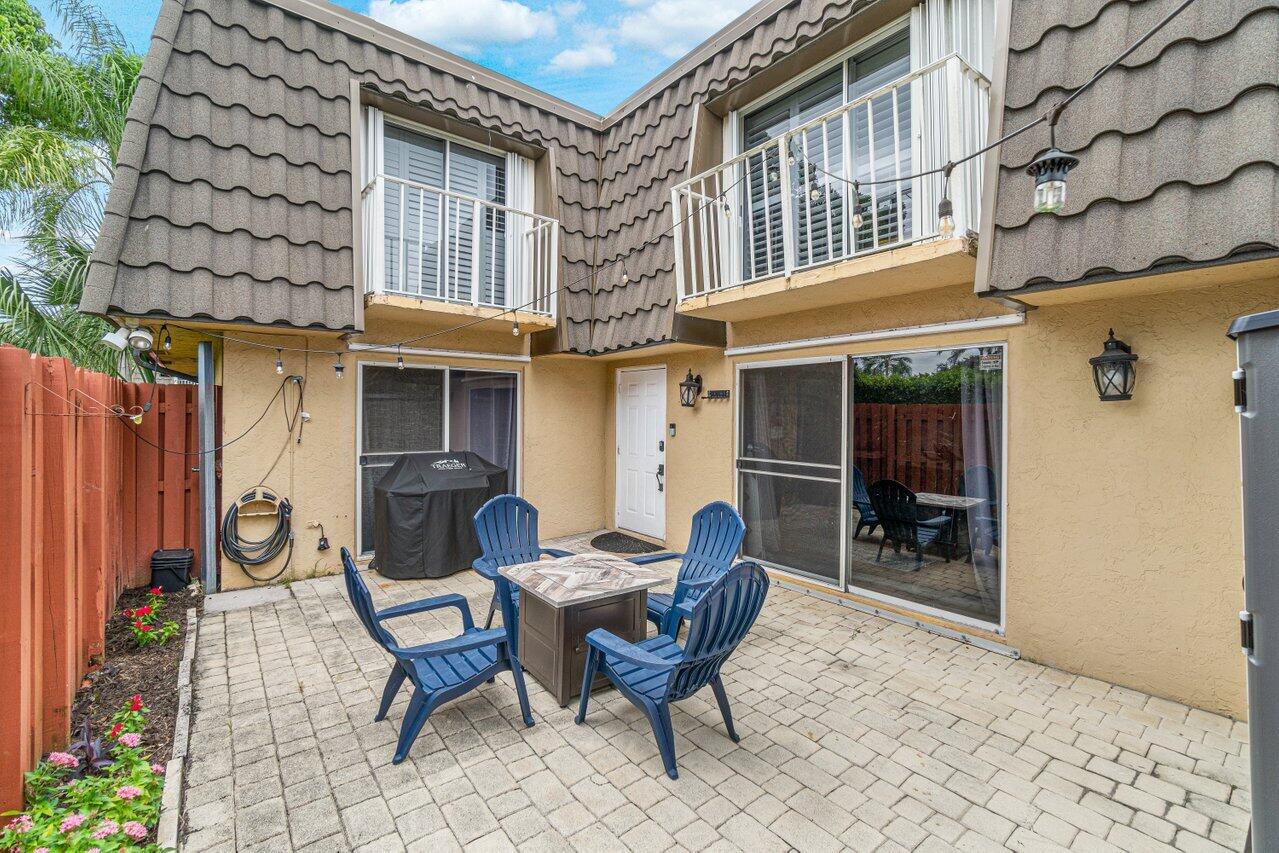 22172 Boca Rancho Drive, Unit D Boca Raton, FL 33428 - Photo 2 of 15 a view of a dinning table and chairs in the back of a building