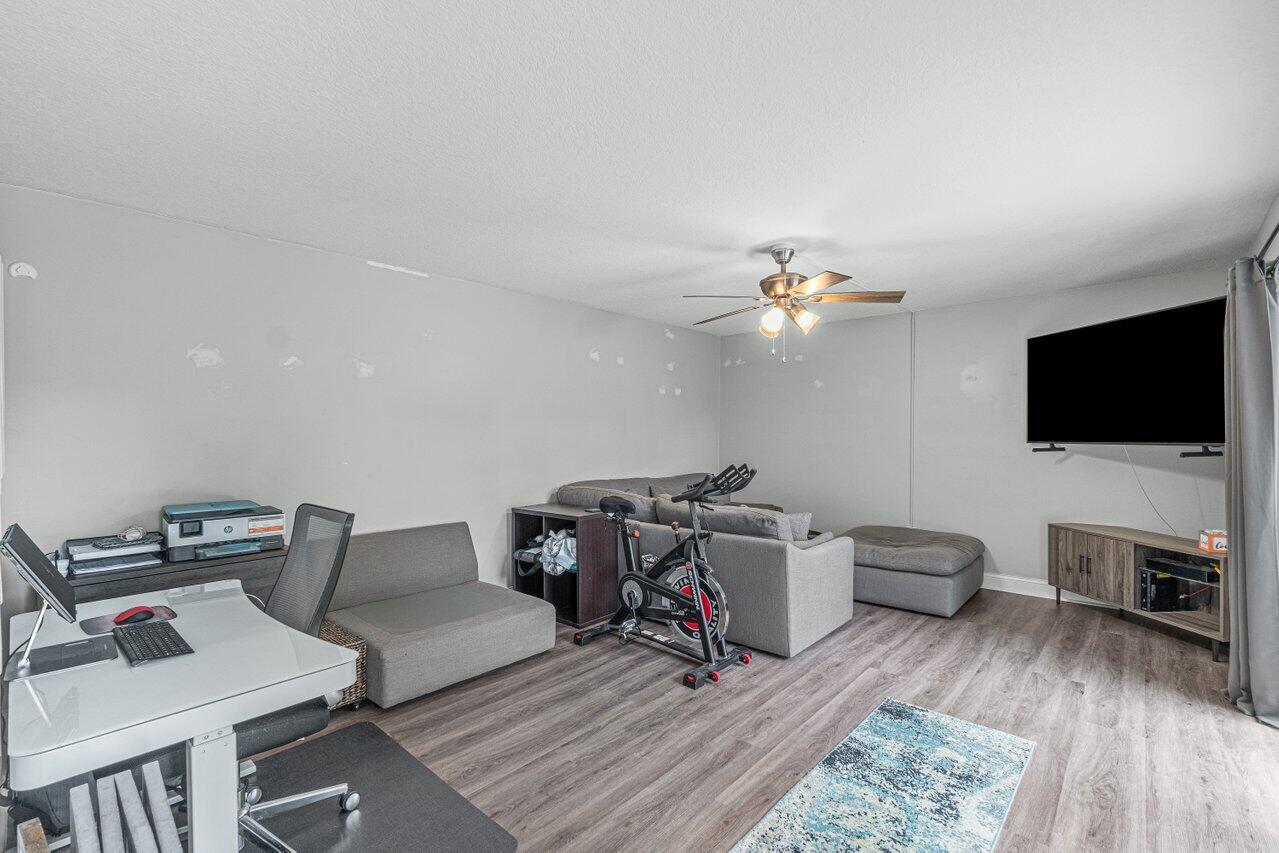 22172 Boca Rancho Drive, Unit D Boca Raton, FL 33428 - Photo 3 of 15 a living room with furniture and a flat screen tv