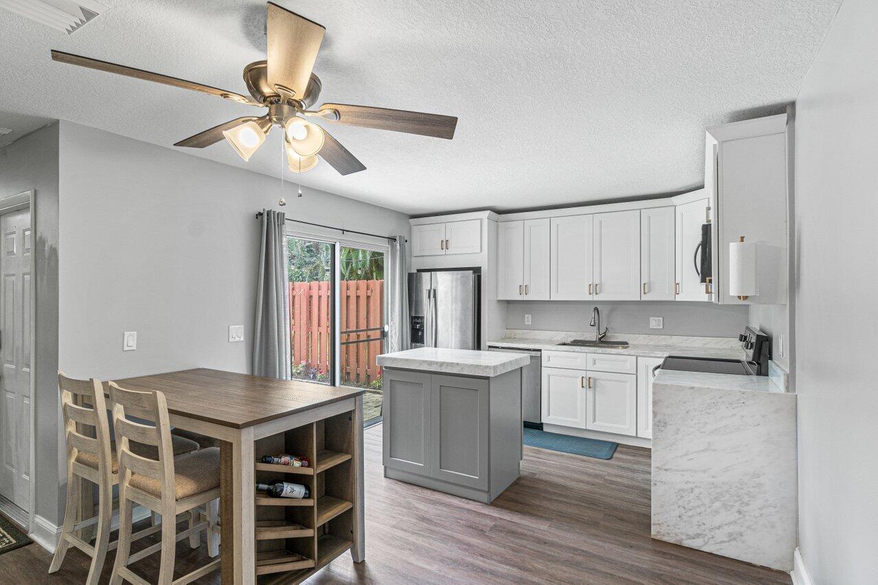 22172 Boca Rancho Drive, Unit D Boca Raton, FL 33428 - Photo 6 of 15 a kitchen with a center island appliances and cabinets