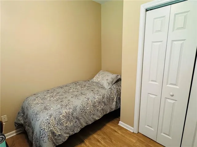 a bed sitting in a bedroom next to a bathroom