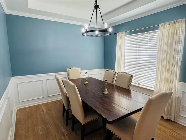 a view of a dining room with furniture and wooden floor