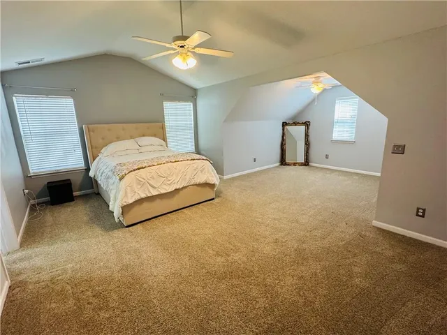 a bedroom with a bed dresser and a window