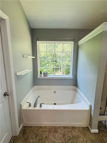 a bathroom with a bathtub and shower