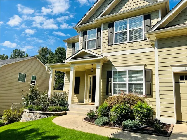 a front view of a house with garden