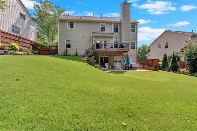 a view of a house with backyard porch and sitting area