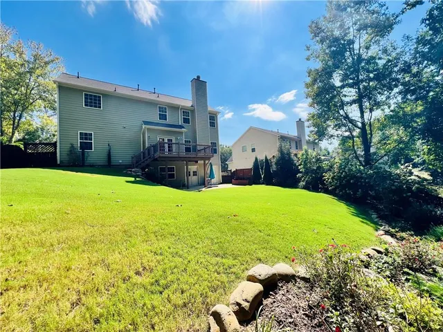 a swimming pool with outdoor seating and yard