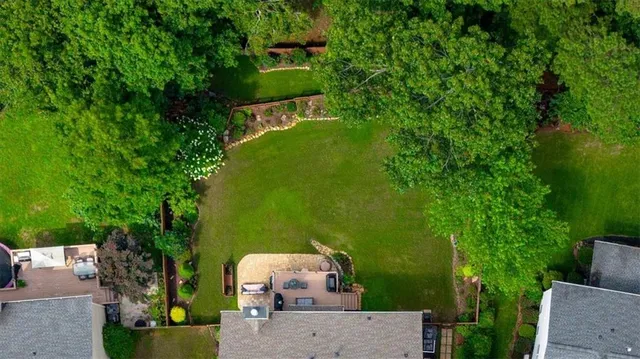 an aerial view of a house with a yard basket ball court and outdoor seating