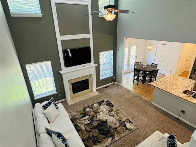 a living room with furniture fireplace and a flat screen tv