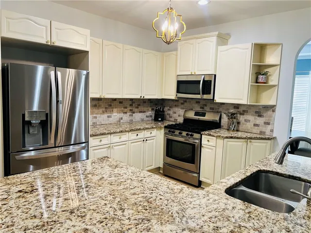 a kitchen with a refrigerator stove and microwave