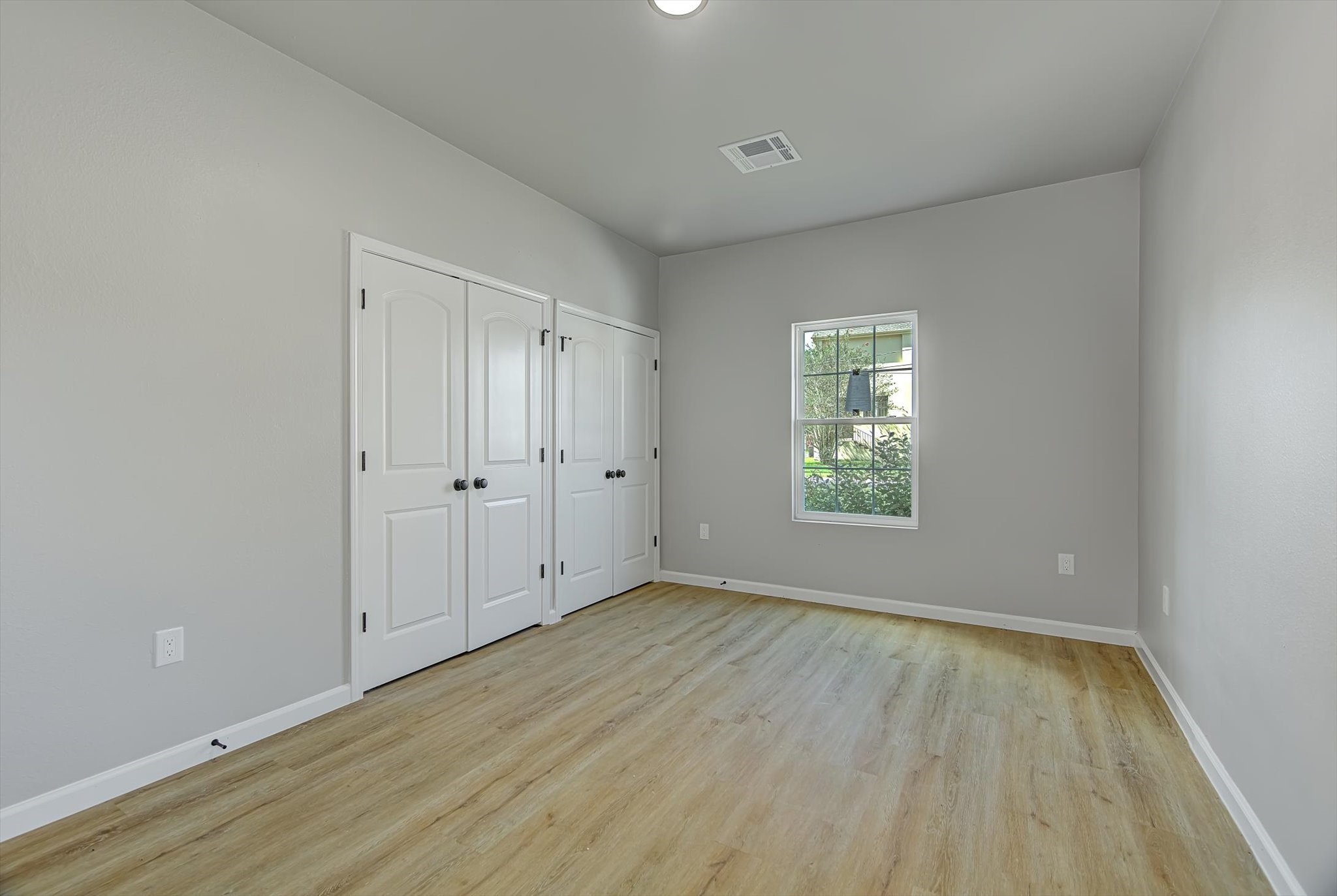 2355 Pecan Street Beaumont, TX 77701 - Photo 18 of 34 a view of an empty room with wooden floor and a window