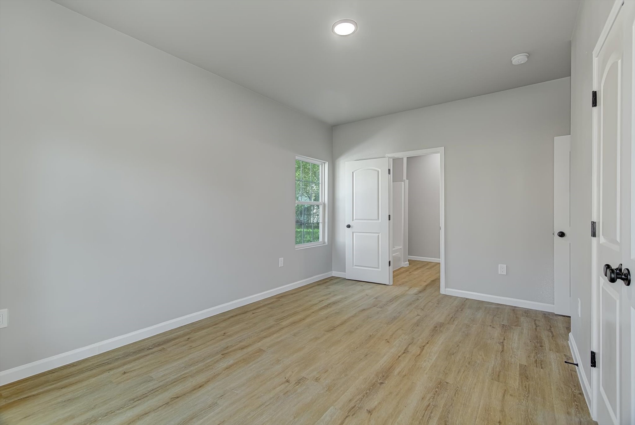 2355 Pecan Street Beaumont, TX 77701 - Photo 20 of 34 a view of an empty room with wooden floor and a window