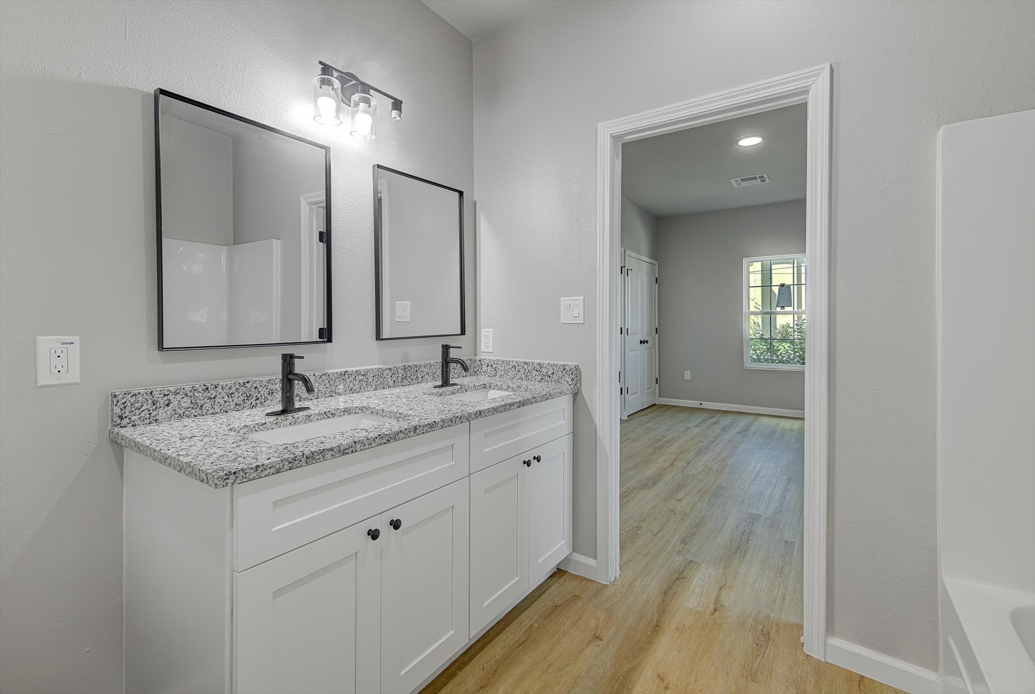 2355 Pecan Street Beaumont, TX 77701 - Photo 23 of 34 a bathroom with a granite countertop sink and a mirror