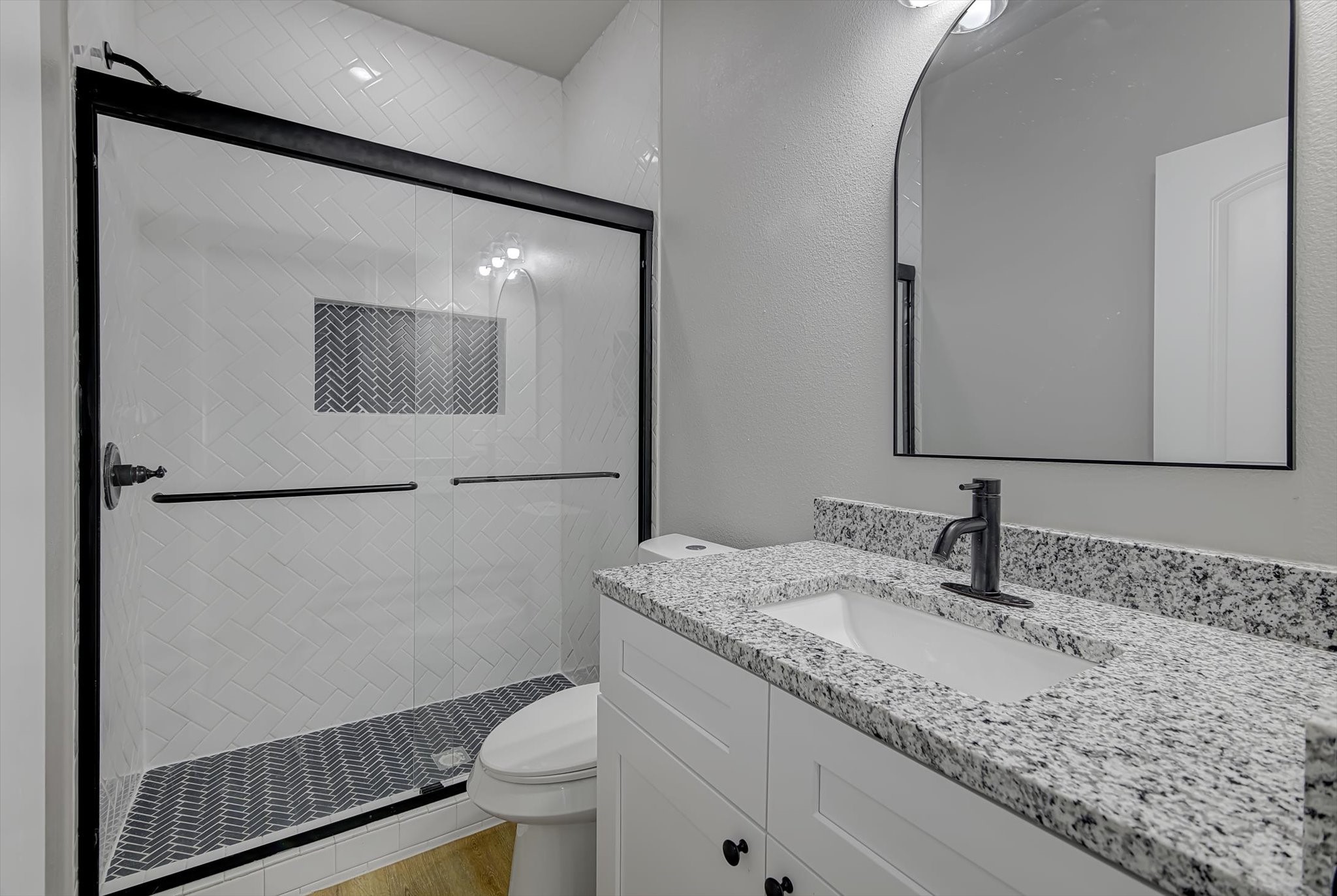 2355 Pecan Street Beaumont, TX 77701 - Photo 29 of 34 a bathroom with a granite countertop sink toilet and mirror