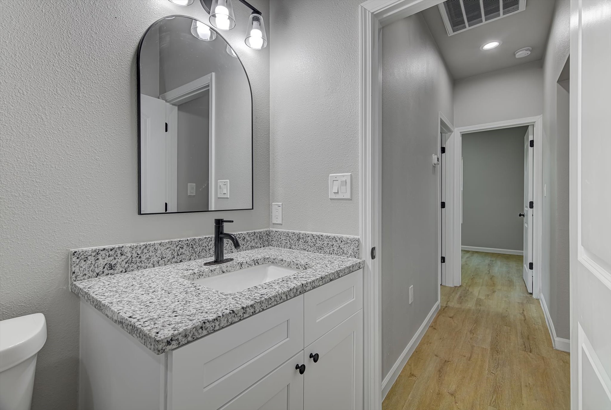 2355 Pecan Street Beaumont, TX 77701 - Photo 30 of 34 a bathroom with a granite countertop sink and a mirror