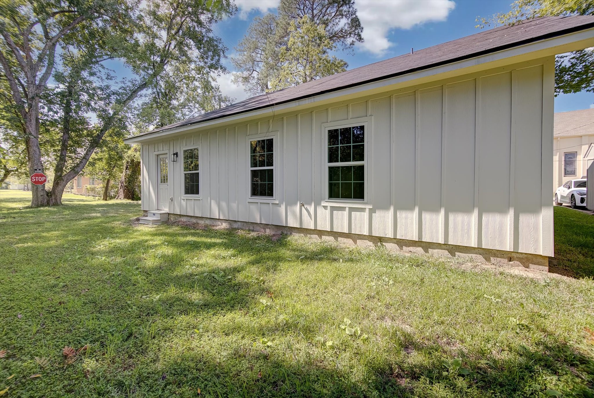 2355 Pecan Street Beaumont, TX 77701 - Photo 34 of 34 a backyard of a house with wooden fence and large trees