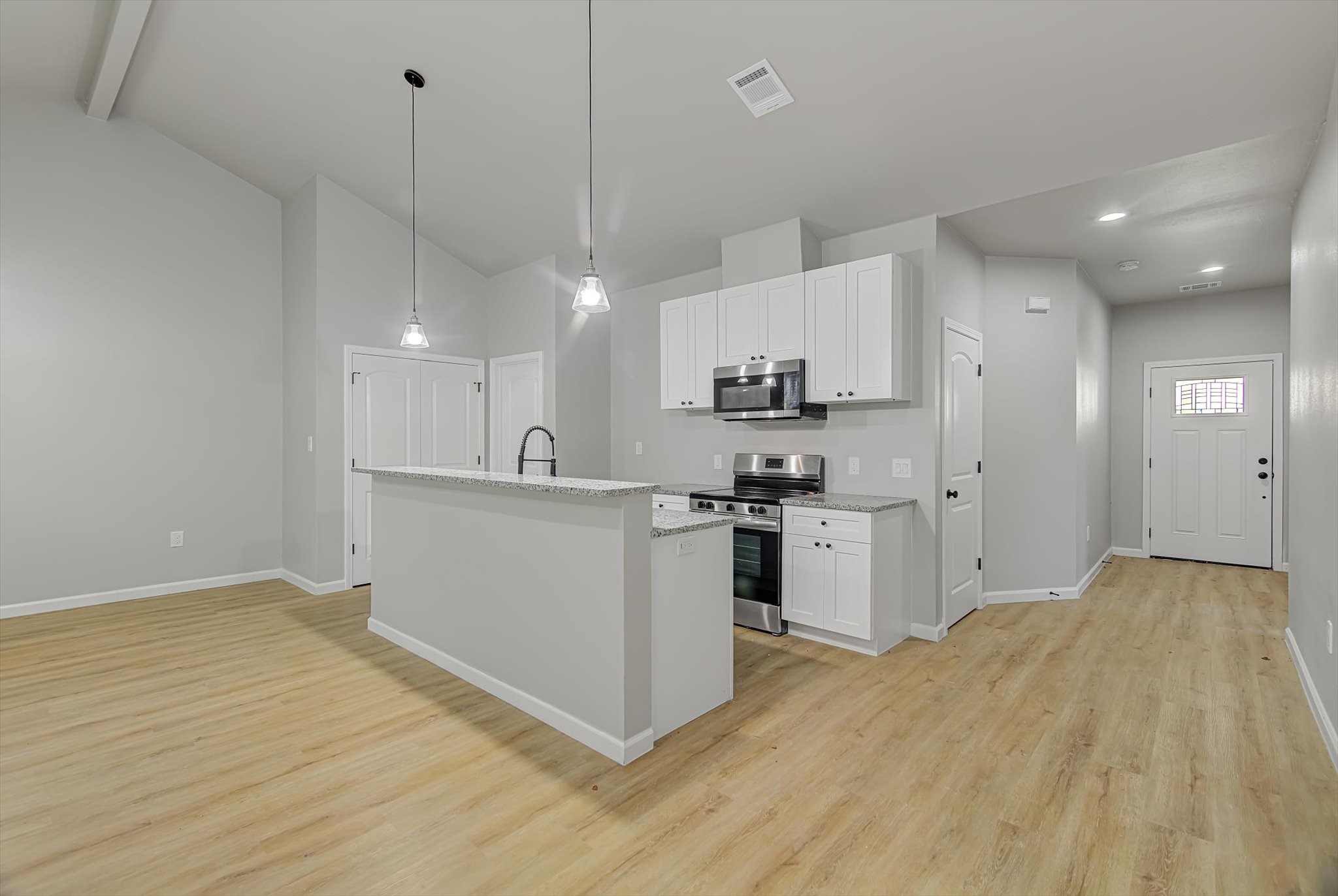 2355 Pecan Street Beaumont, TX 77701 - Photo 8 of 34 a kitchen with white cabinets and stainless steel appliances