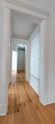 a view of an empty room and wooden floor