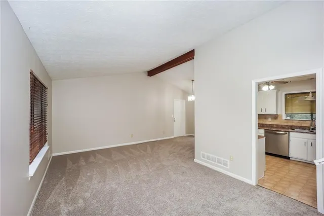 an empty room with a kitchen