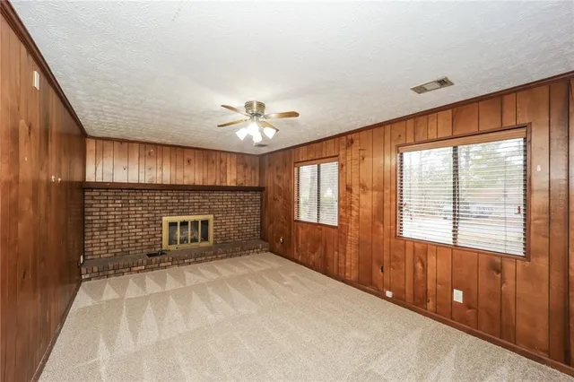 a view of an empty room with a fireplace