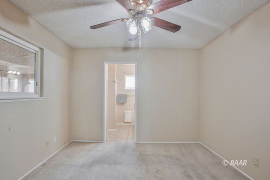 1144 West St George Avenue Ridgecrest, CA 93555 - Photo 11 of 18 wooden floor in an empty room with a window