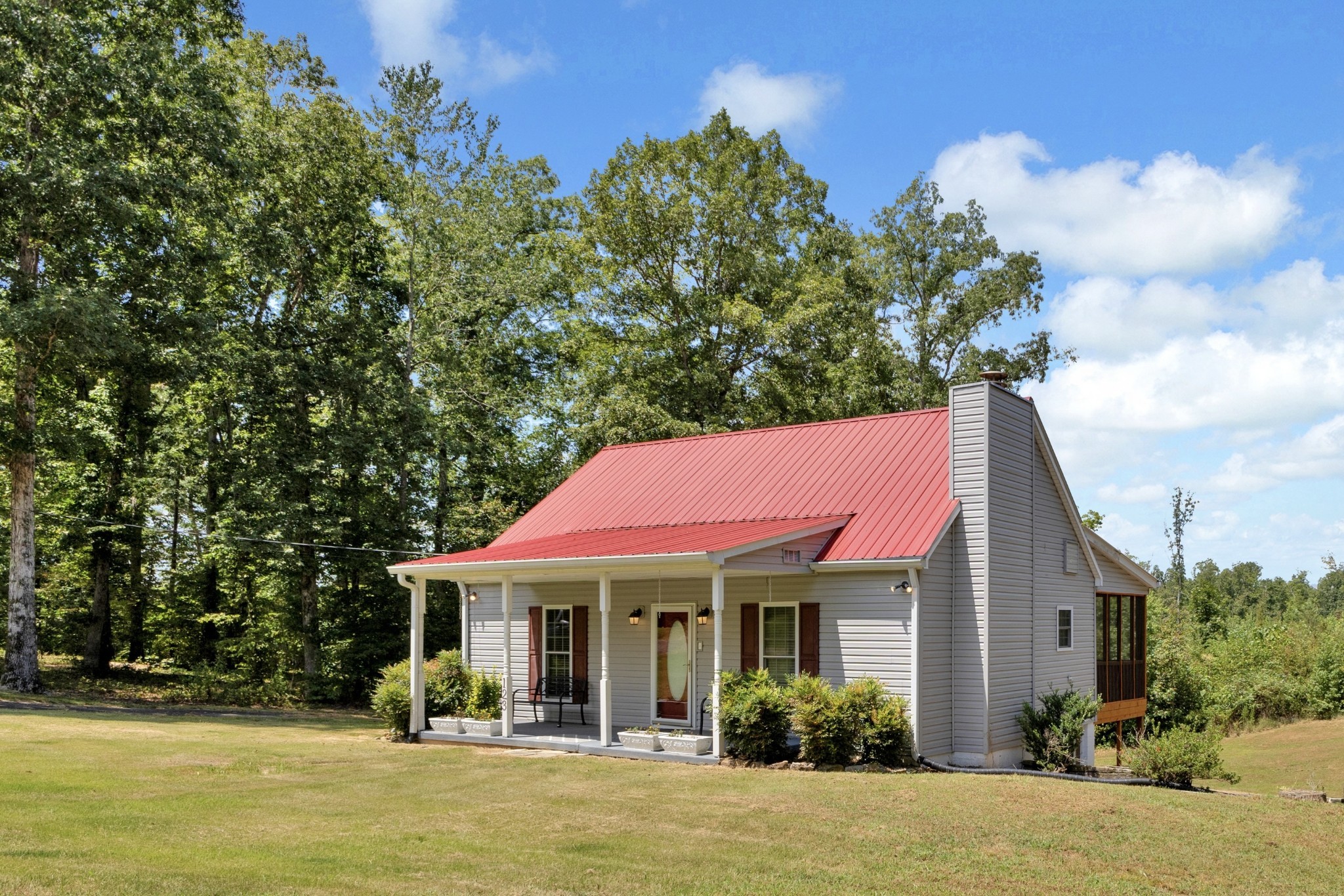 123 Lower Roans Creek Road Linden, TN 37096 - Photo 1 of 33 a front view of a house with swimming pool