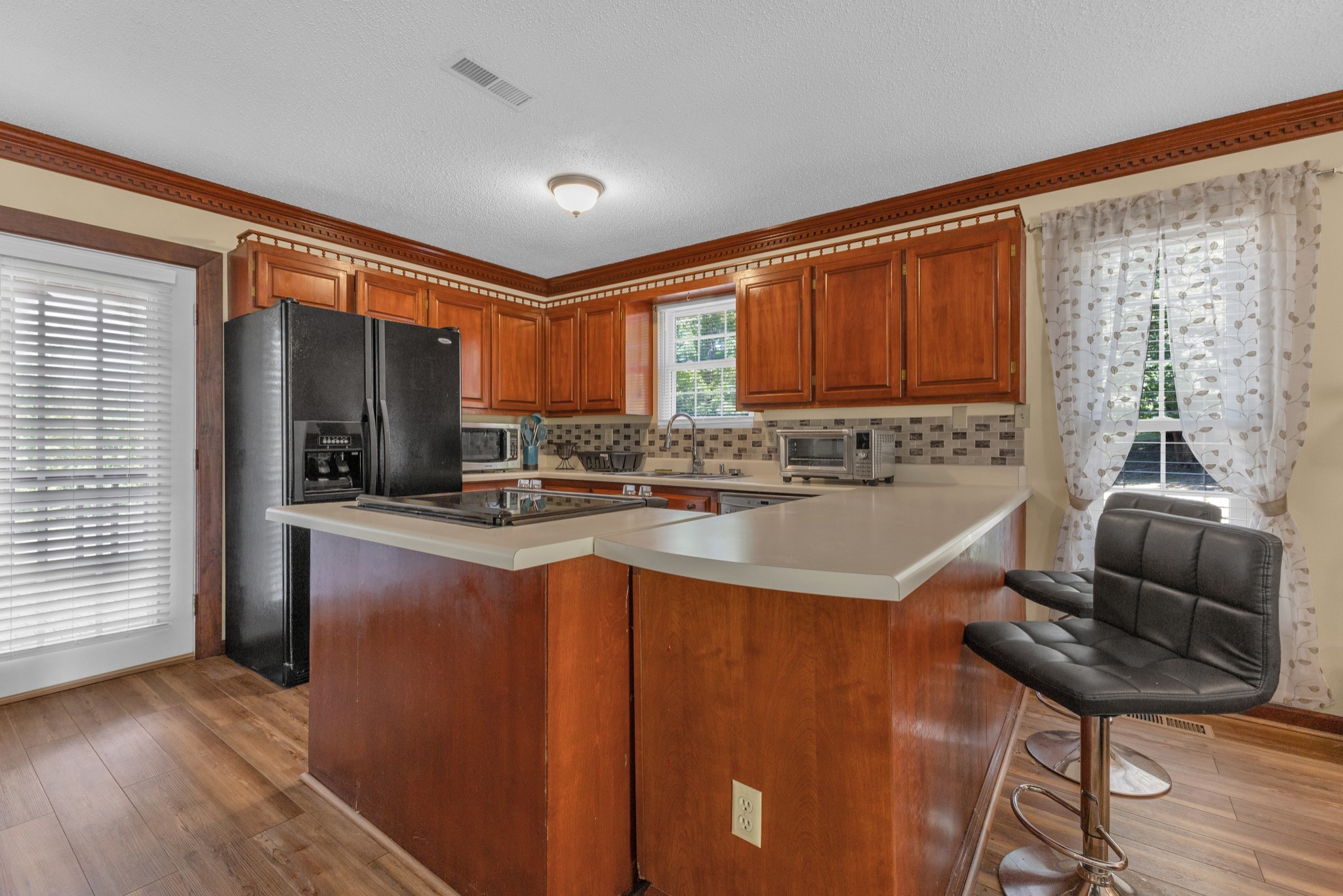 123 Lower Roans Creek Road Linden, TN 37096 - Photo 15 of 33 a kitchen with stainless steel appliances granite countertop a refrigerator sink and cabinets