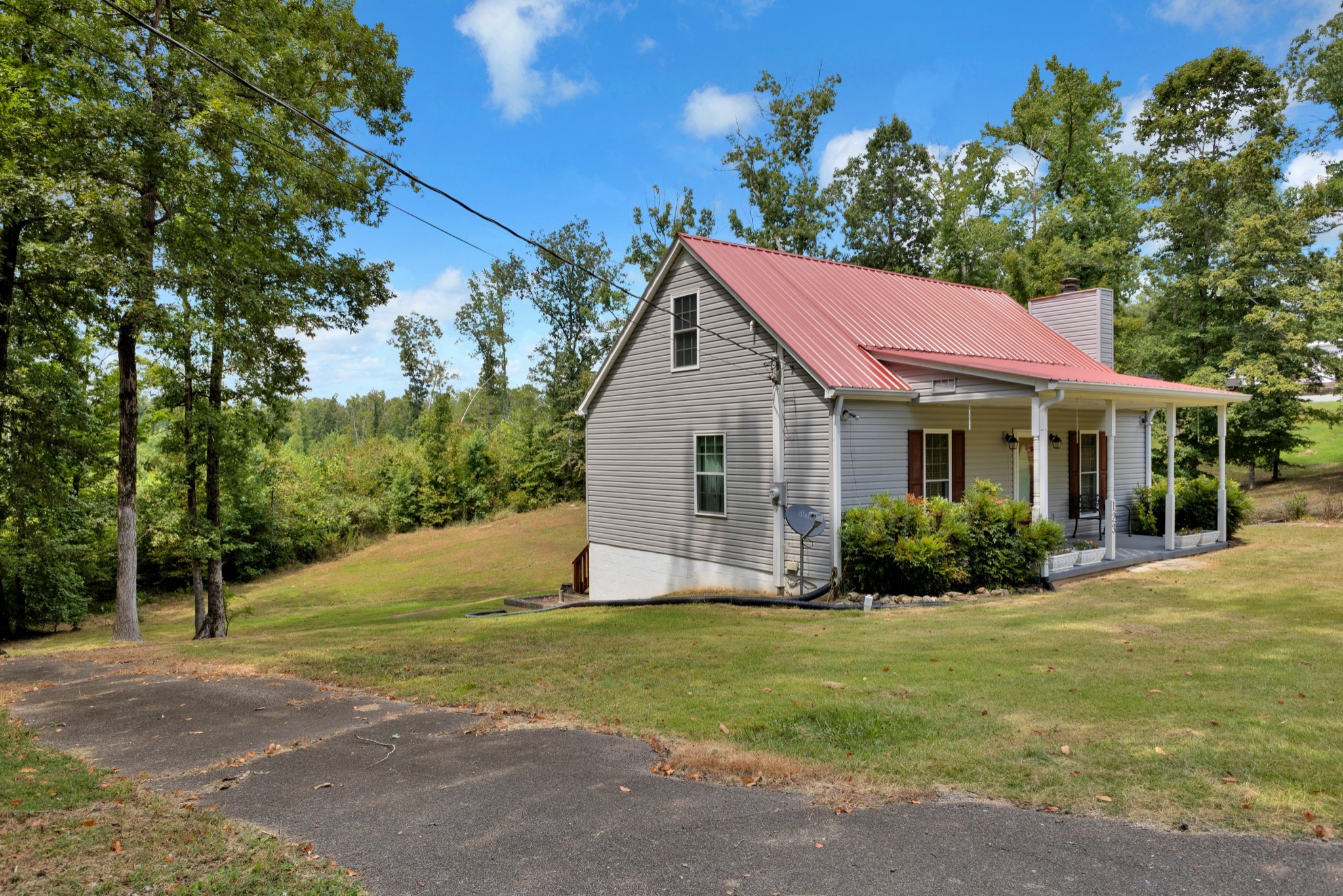 123 Lower Roans Creek Road Linden, TN 37096 - Photo 4 of 33 a front view of a house with a yard and trees