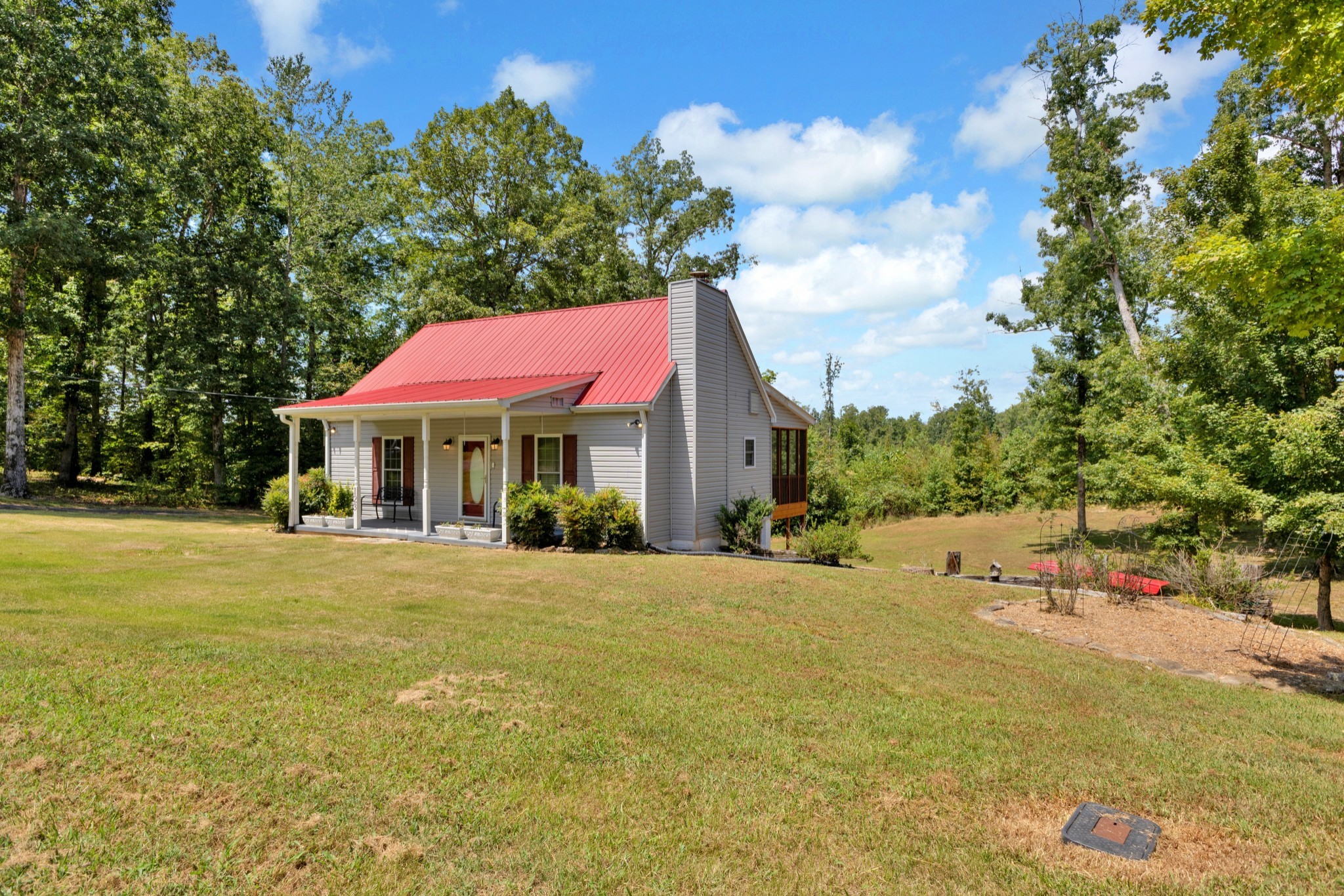 123 Lower Roans Creek Road Linden, TN 37096 - Photo 5 of 33 a view of a house with a yard and sitting area