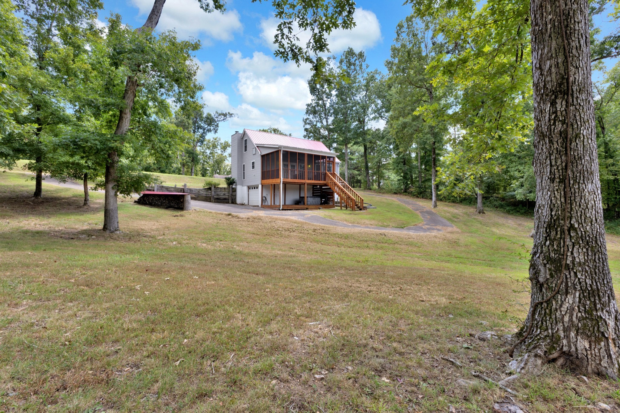 123 Lower Roans Creek Road Linden, TN 37096 - Photo 6 of 33 a view of a house with a yard and large trees