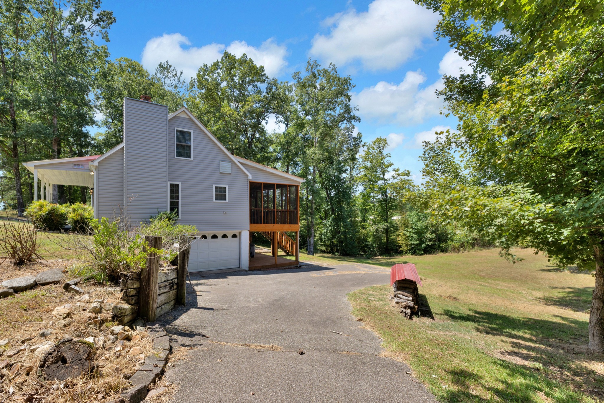 123 Lower Roans Creek Road Linden, TN 37096 - Photo 9 of 33 a view of a backyard with chair and flower plants