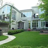 a front view of a house with a yard table and chairs