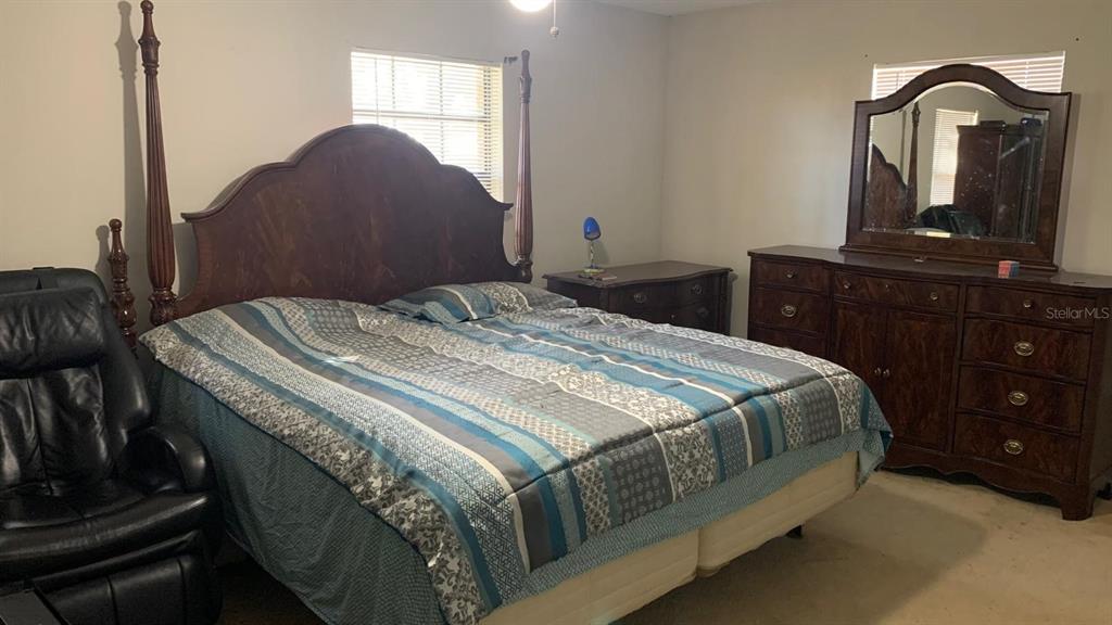 8510 North Campbell Road Lakeland, FL 33810 - Photo 12 of 15 a bedroom with a bed and dresser