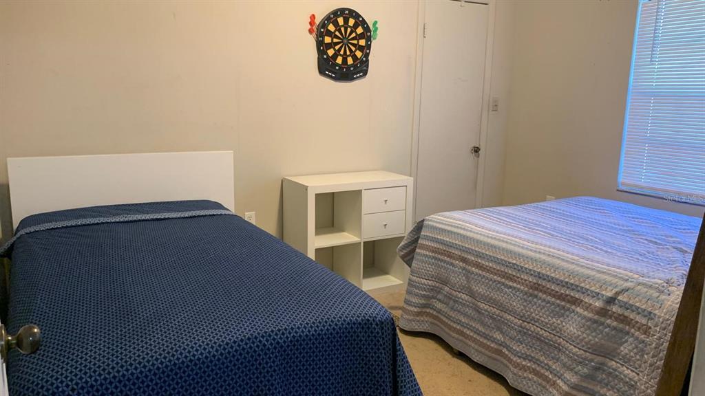 8510 North Campbell Road Lakeland, FL 33810 - Photo 14 of 15 a bedroom with a bed and a table