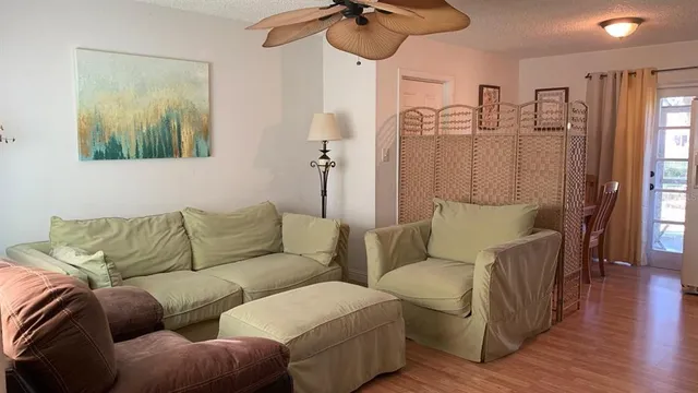 a living room with furniture and a wooden floor