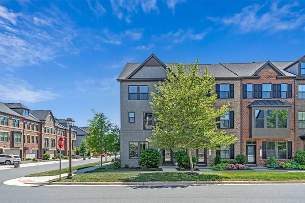 a front view of a residential apartment building with a yard