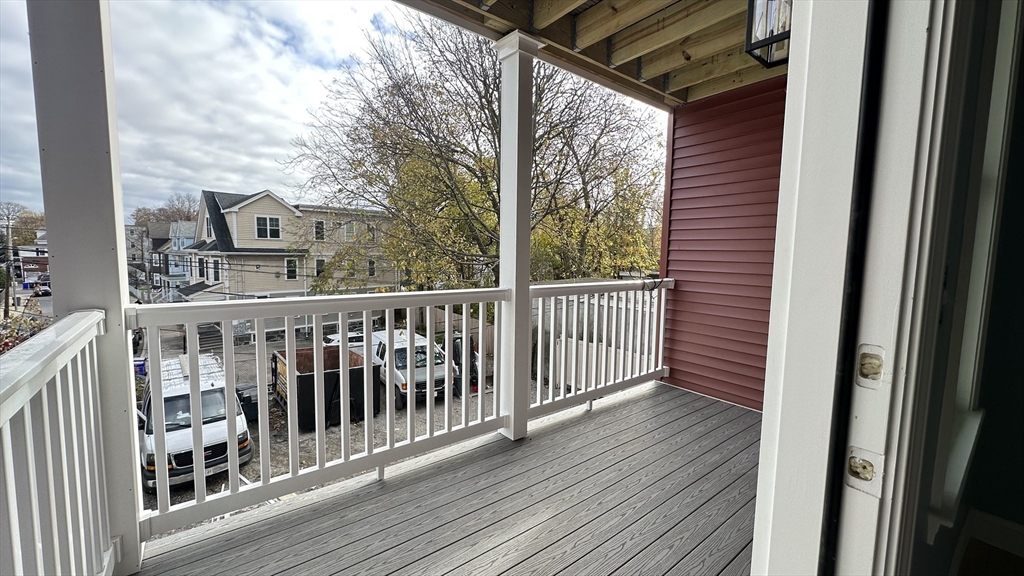 663 Columbia Road, Unit 1 Boston, MA 02125 - Photo 12 of 12 a view of a balcony with wooden floor